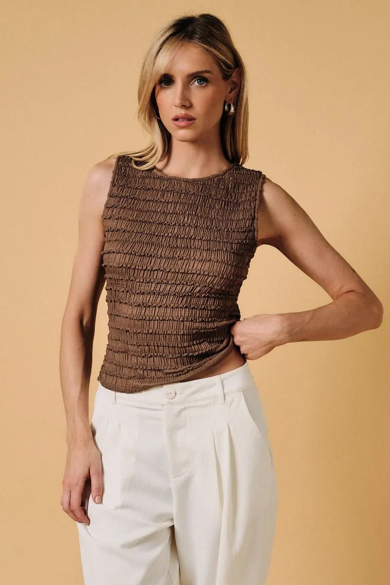 Brown smocked sleeveless top with fitted textured design complementing the boat neck short sleeve style
