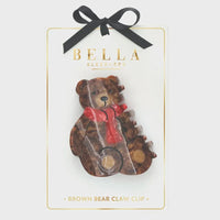 A brown bear claw clip with a translucent marbled finish and a red scarf detail for stylish hair styling