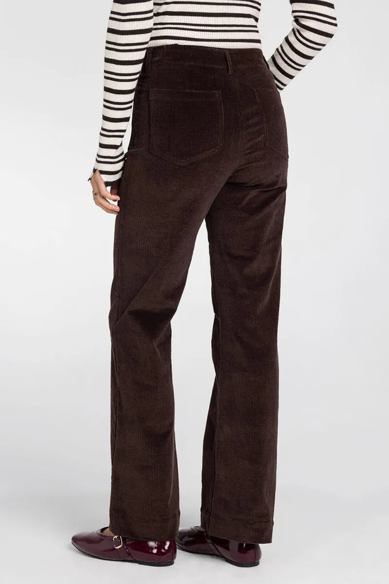 Brown corduroy high waist flare pants with multiple pockets shown from the back in thread and supply gladys pants
