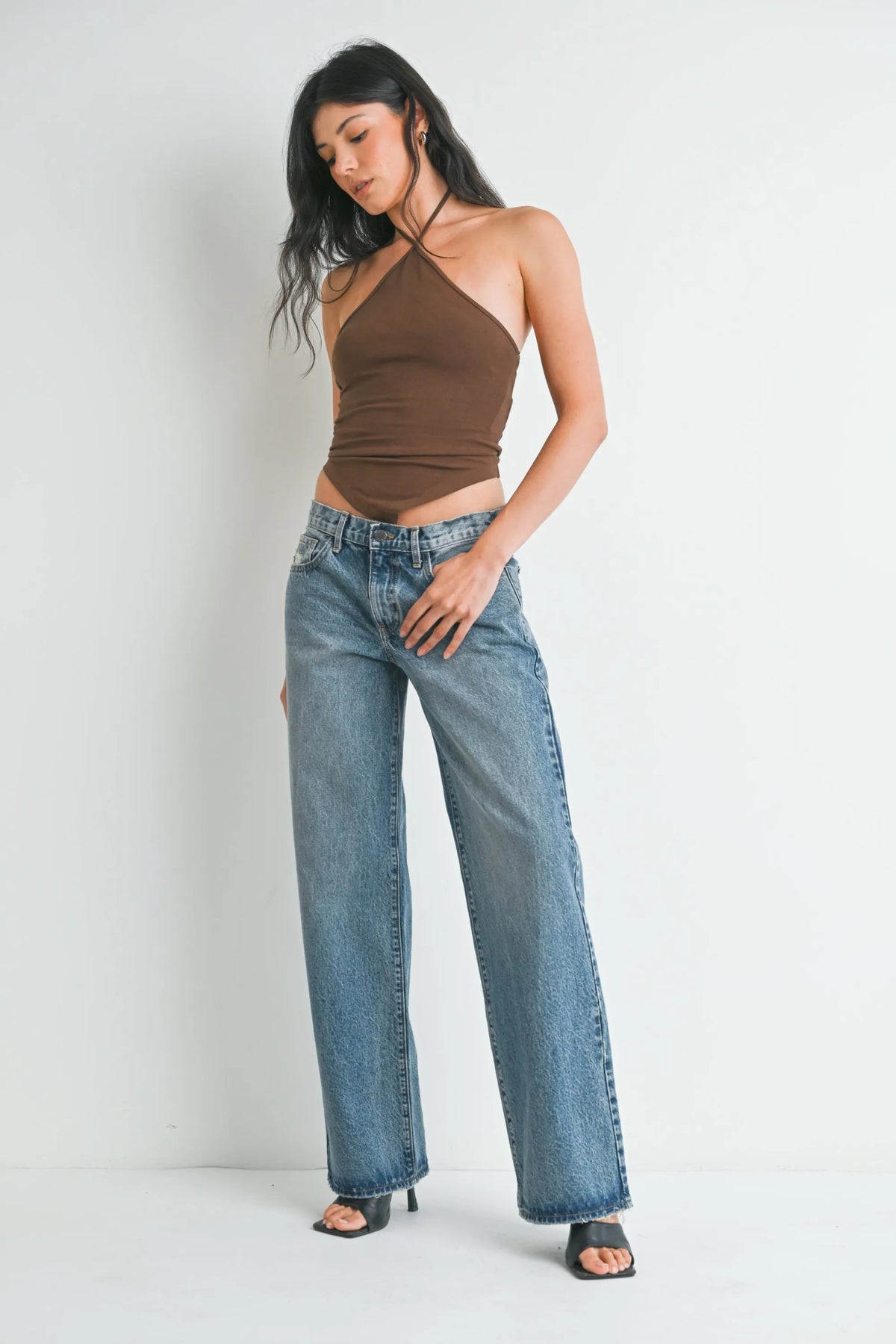 Brown halter top with waistline cutout paired with low rise baggy slouchy denim jeans in casual style
