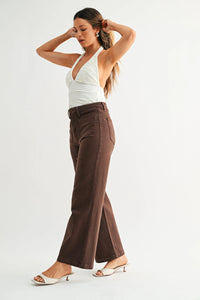 Brown high-waisted flared denim jeans with classic texture and patch pockets featuring subtle stitching details