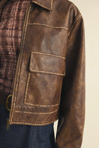 Brown leather coated knit boxy utility jacket with textured distressed finish and gold toned stitching along seams