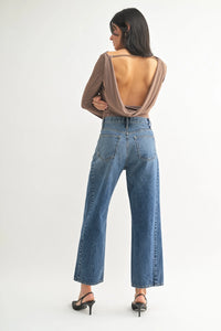 Back view of brown long sleeved top with cutout paired with high rise barrel denim jeans for women’s boho chic clothing shop daisy
