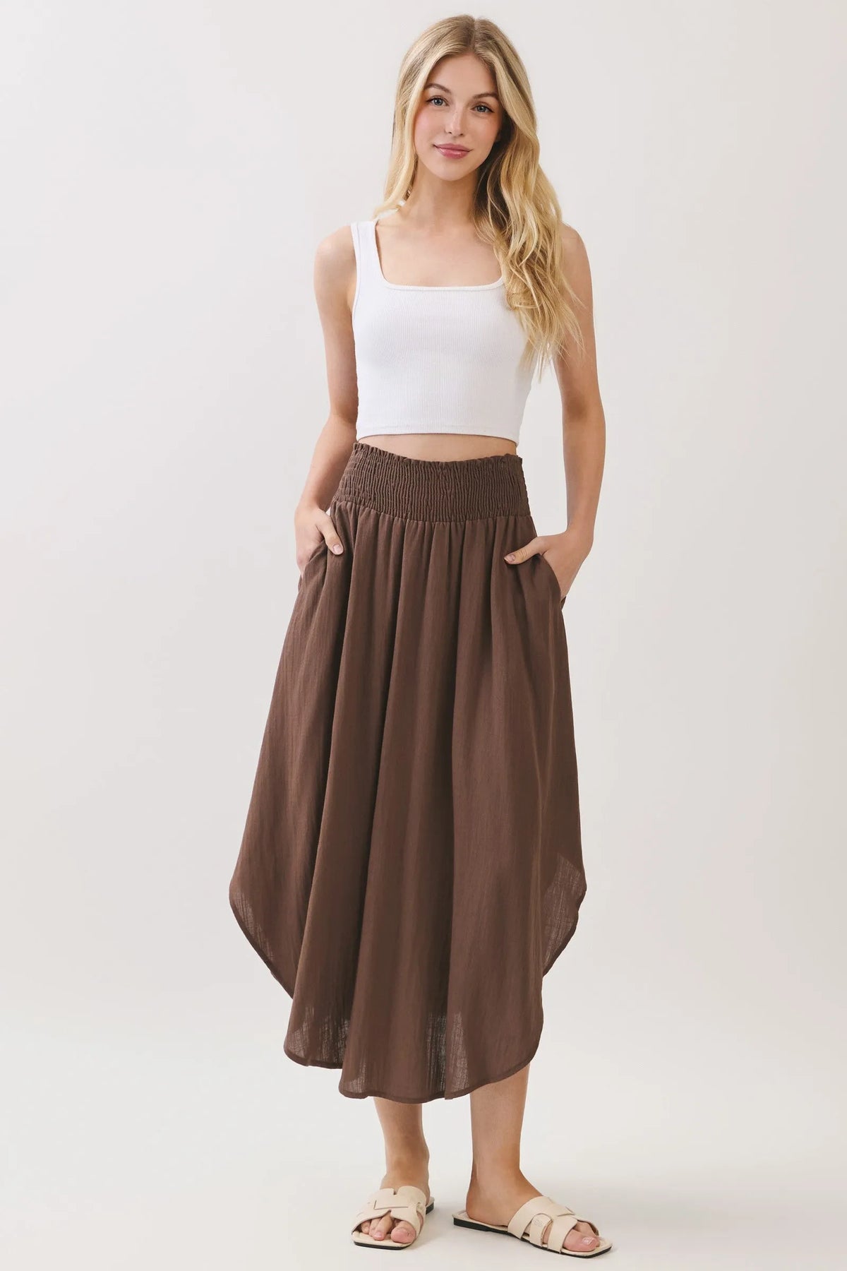 Brown flowing rounded hem midi skirt with smocked waistband lined and side pockets for comfortable wear