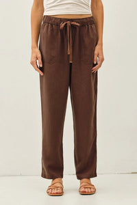 Brown tencel tapered pants with a relaxed fit and two front pockets made from soft breathable fabric