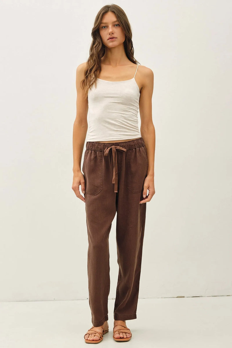 Brown tencel tapered pants with a relaxed fit drawstring waist and two side pockets for comfortable wear