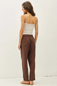 Brown relaxed-fit tencel tapered pants with elastic waistband and two front pockets for comfortable wear