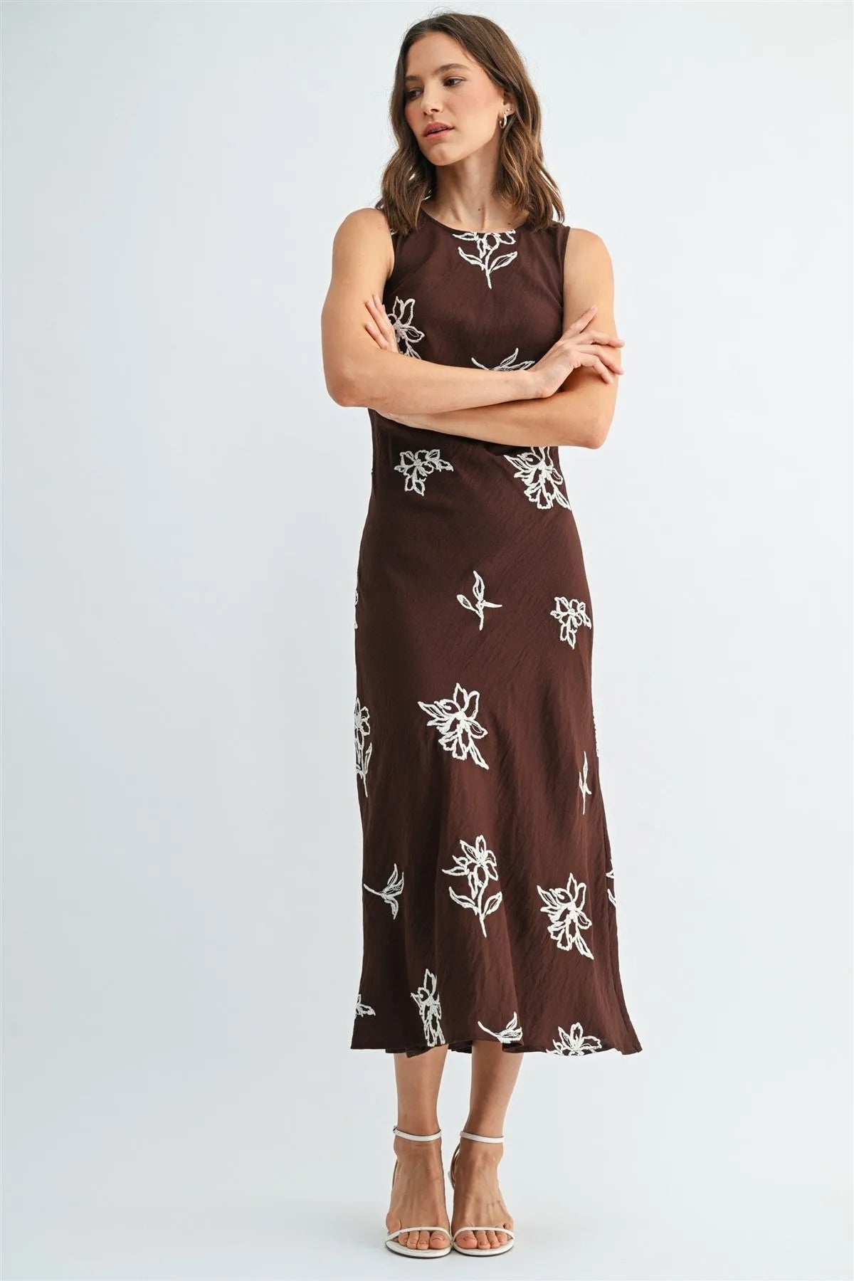 A brown satin embroidery sleeveless midi dress with white floral embroidery detailing