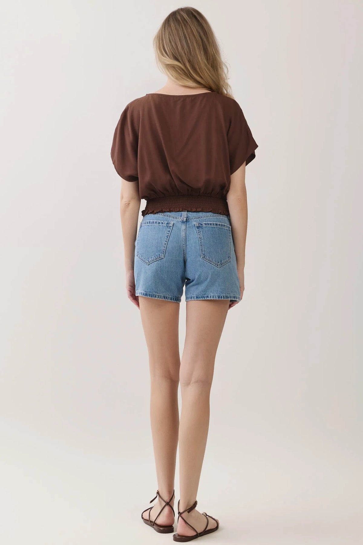Brown short-sleeved neck button detailed blouse with relaxed fit and ruffled hemline for casual wear