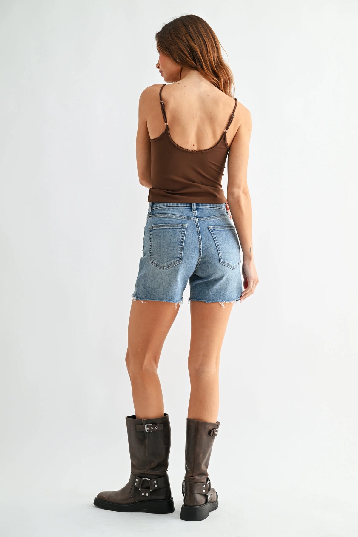 Back view of brown spaghetti strap top with cutout on low rise walking denim short
