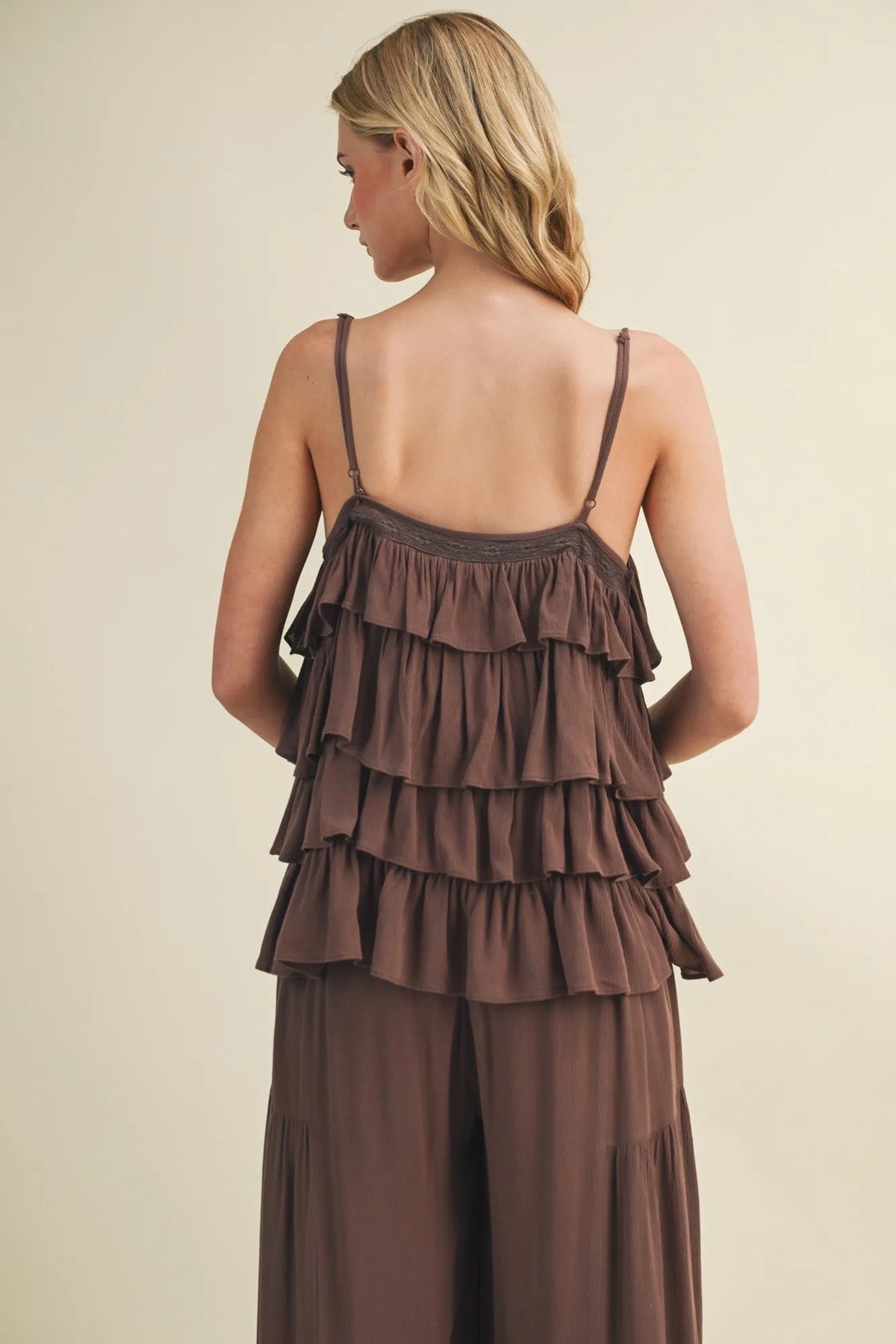 A brown cascading ruffle tiered v neck camisole top with thin straps paired with matching wide-leg pants set