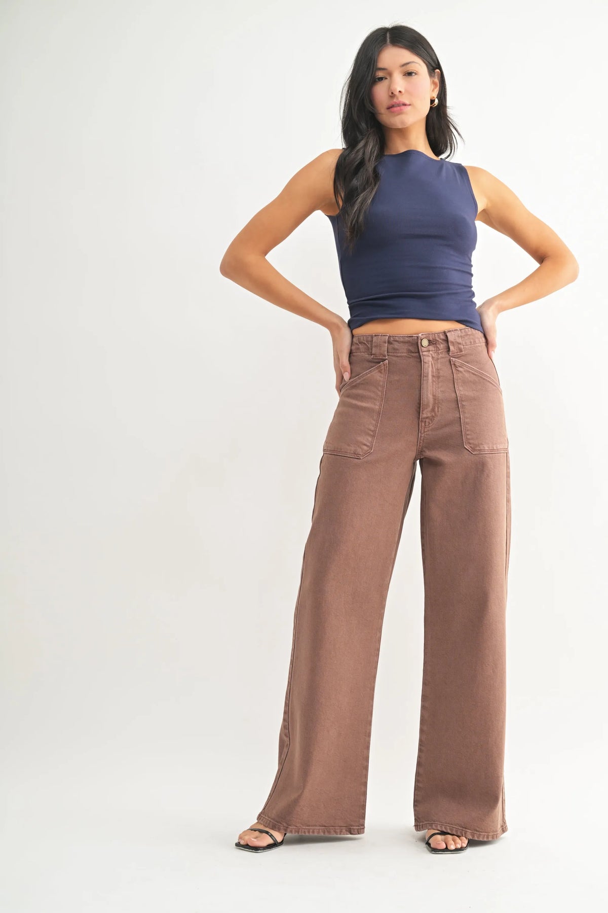 Brown high rise patch pocket wide leg flare denim jeans with front pockets and a relaxed fit silhouette
