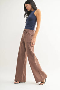 Brown high waist wide leg flare denim jeans with patch pockets on front in a casual style