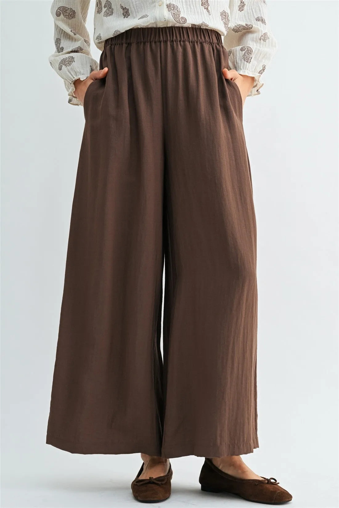 Brown wide leg pants with an elastic waist and two front pockets for comfortable everyday wear