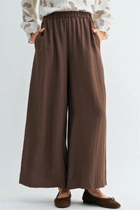 Brown wide leg pants with an elastic waist and two front pockets for comfortable everyday wear