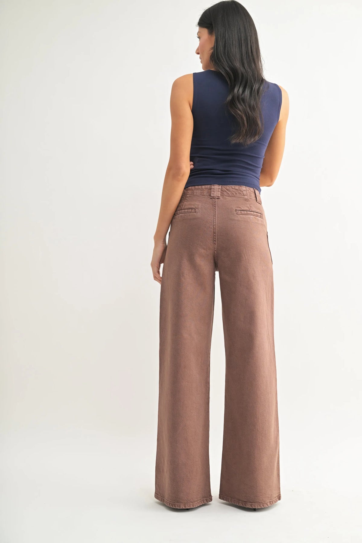 Brown high rise patch pocket wide leg flare denim jeans with relaxed fit and subtle stitching details