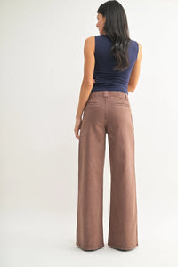 Brown high rise patch pocket wide leg flare denim jeans with relaxed fit and subtle stitching details