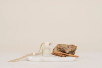 Hanging car fragrance diffuser with clear glass bottle white cap and braided beige cord for car diffuser use