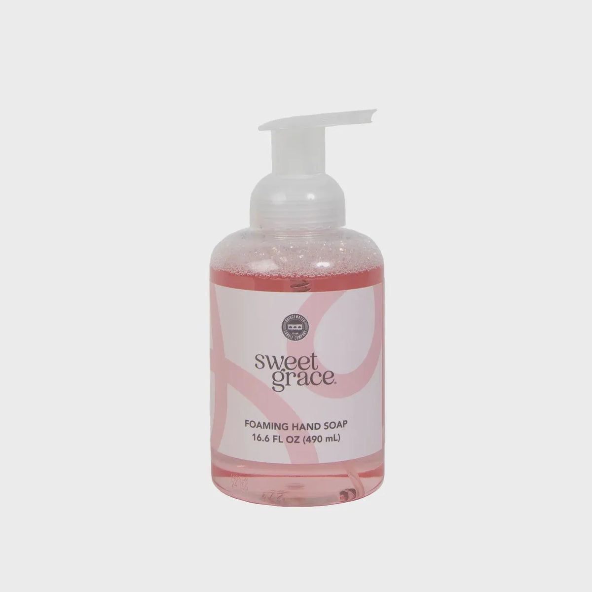 A clear plastic bottle of sweet grace foaming hand soap with a white pump and pink foaming soap inside