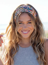 A colorful floral-patterned boho bandeau headband with cream borders made of soft woven fabric
