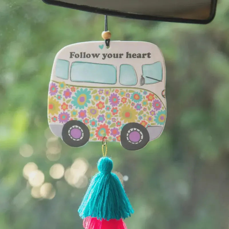 Car air freshener shaped like a colorful floral-patterned van with a turquoise tassel for car air use
