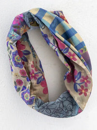Full boho bandeau headband with floral patchwork in soft beige, blue, pink, and purple gingham floral patchwork pattern