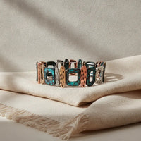 Patina geometric stretch bracelet featuring colorful turquoise copper and silver-toned rectangular links with textured surfaces