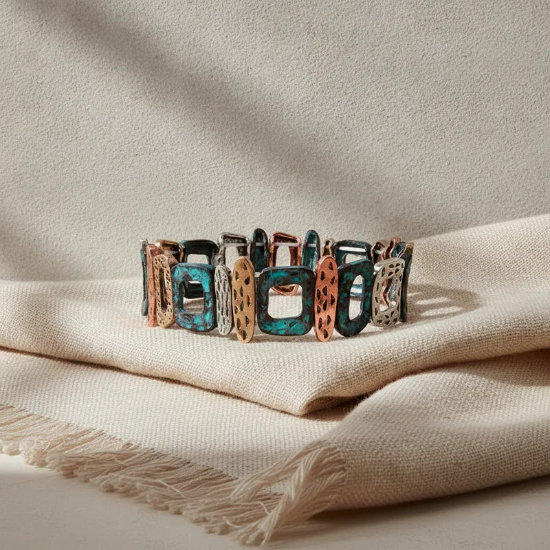 Patina geometric stretch bracelet featuring colorful turquoise copper and silver-toned rectangular links with textured surfaces