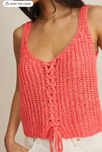 Coral-colored knitted tate laceup sweater tank with sleeveless design, lace-up front, and drawstring hem