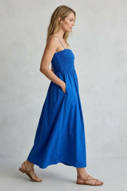 A vibrant royal blue sleeveless cornelia poplin maxi dress with a smocked bodice and flowing skirt