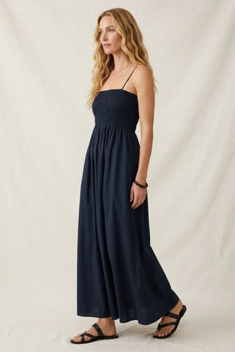 Navy blue cornelia poplin maxi dress with thin spaghetti straps and flowy smocked bodice for elegant wear
