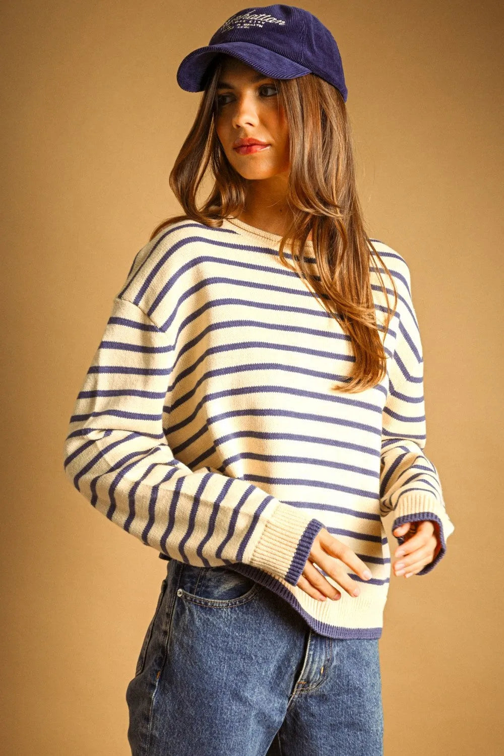 A cozy cream and navy blue striped long sleeve knit sweater with ribbed cuffs and hem perfect for casual wear