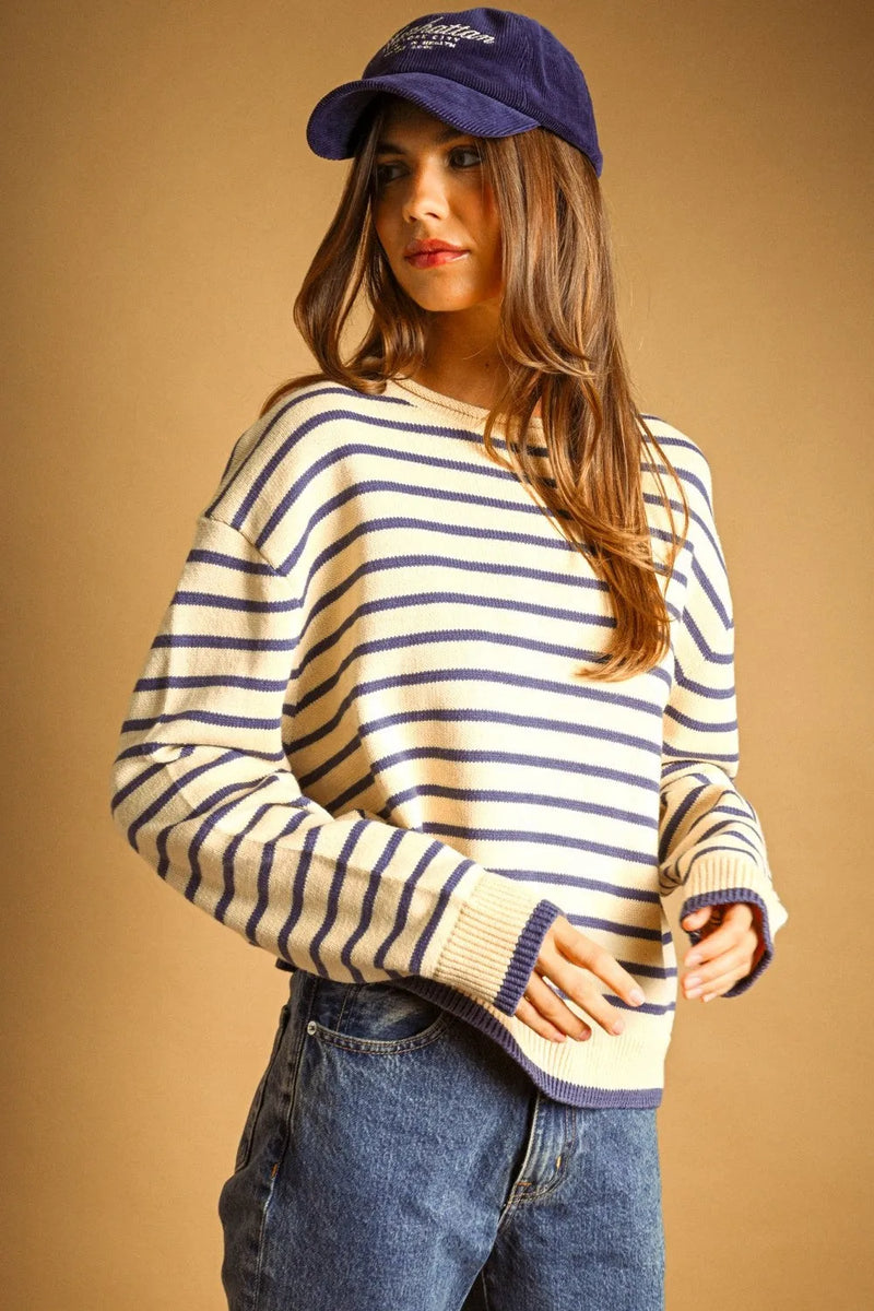 A cozy cream and navy blue striped long sleeve knit sweater with ribbed cuffs and hem perfect for casual wear