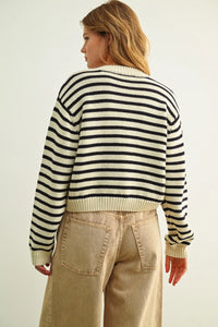 A cozy cropped knit sweater with bold black and cream striped pattern button front knitted cardigan design