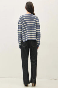 A cozy chunky knit striped open cardigan in navy blue and off-white with long sleeves and horizontal stripes