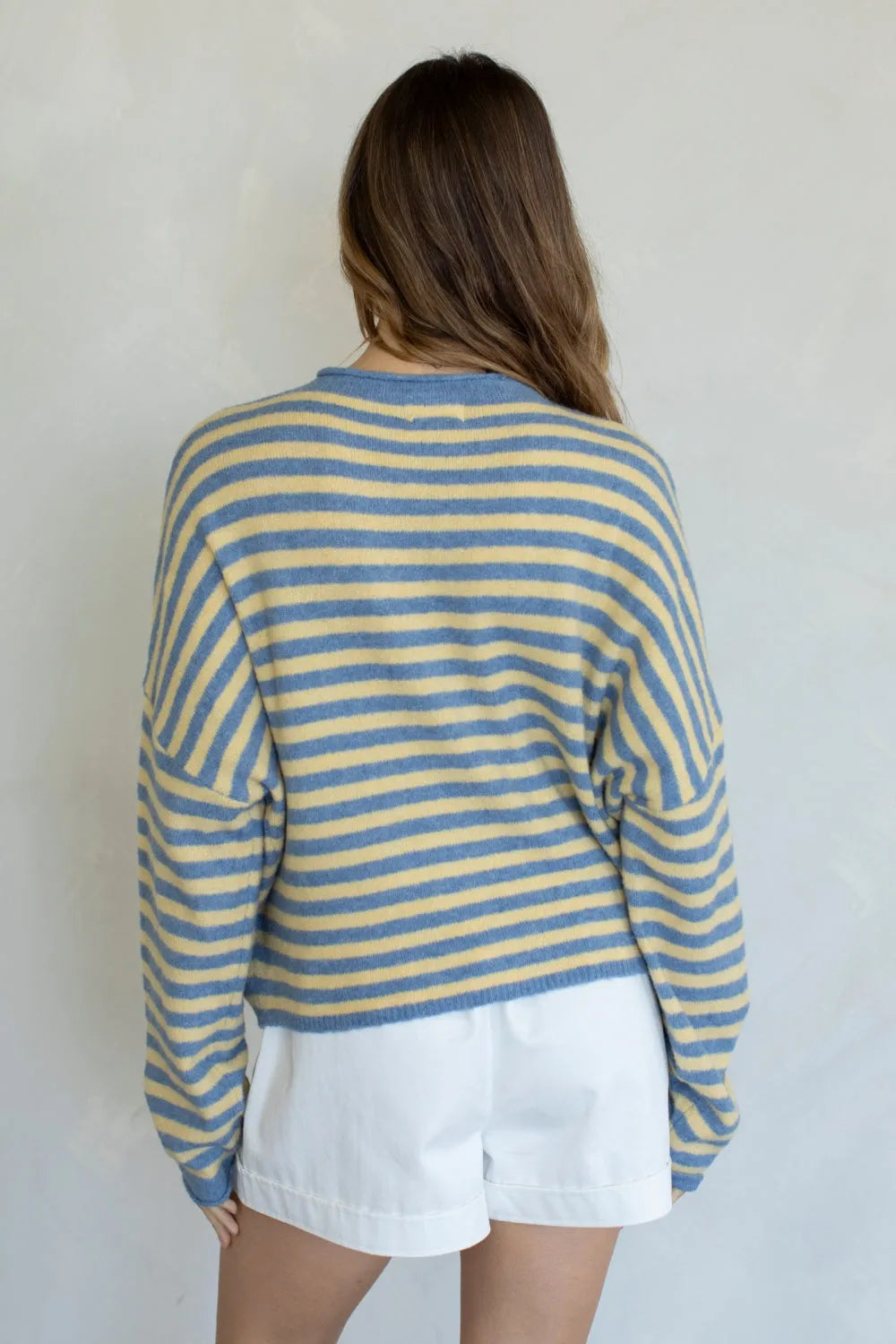 A cozy striped piper pullover sweater with horizontal soft blue and pale yellow stripes in long sleeves