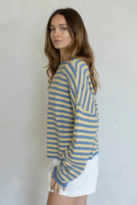 A cozy striped piper pullover sweater featuring horizontal soft blue and pale yellow stripes in long sleeves