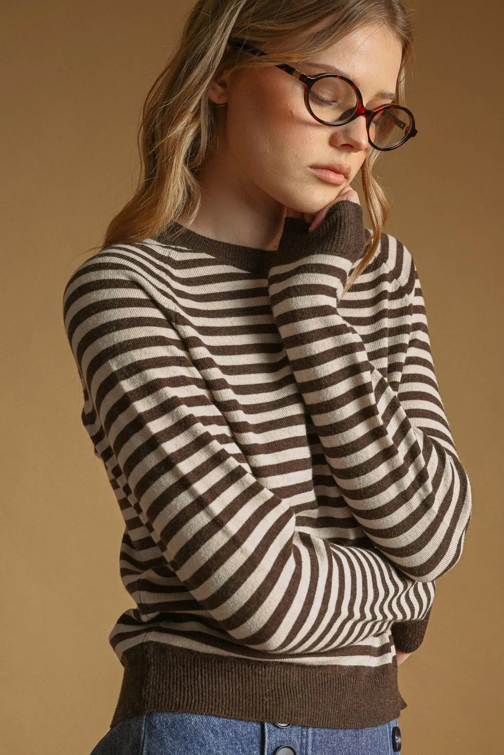 A cozy brown and cream striped round neck sweater with long sleeves perfect for casual wear