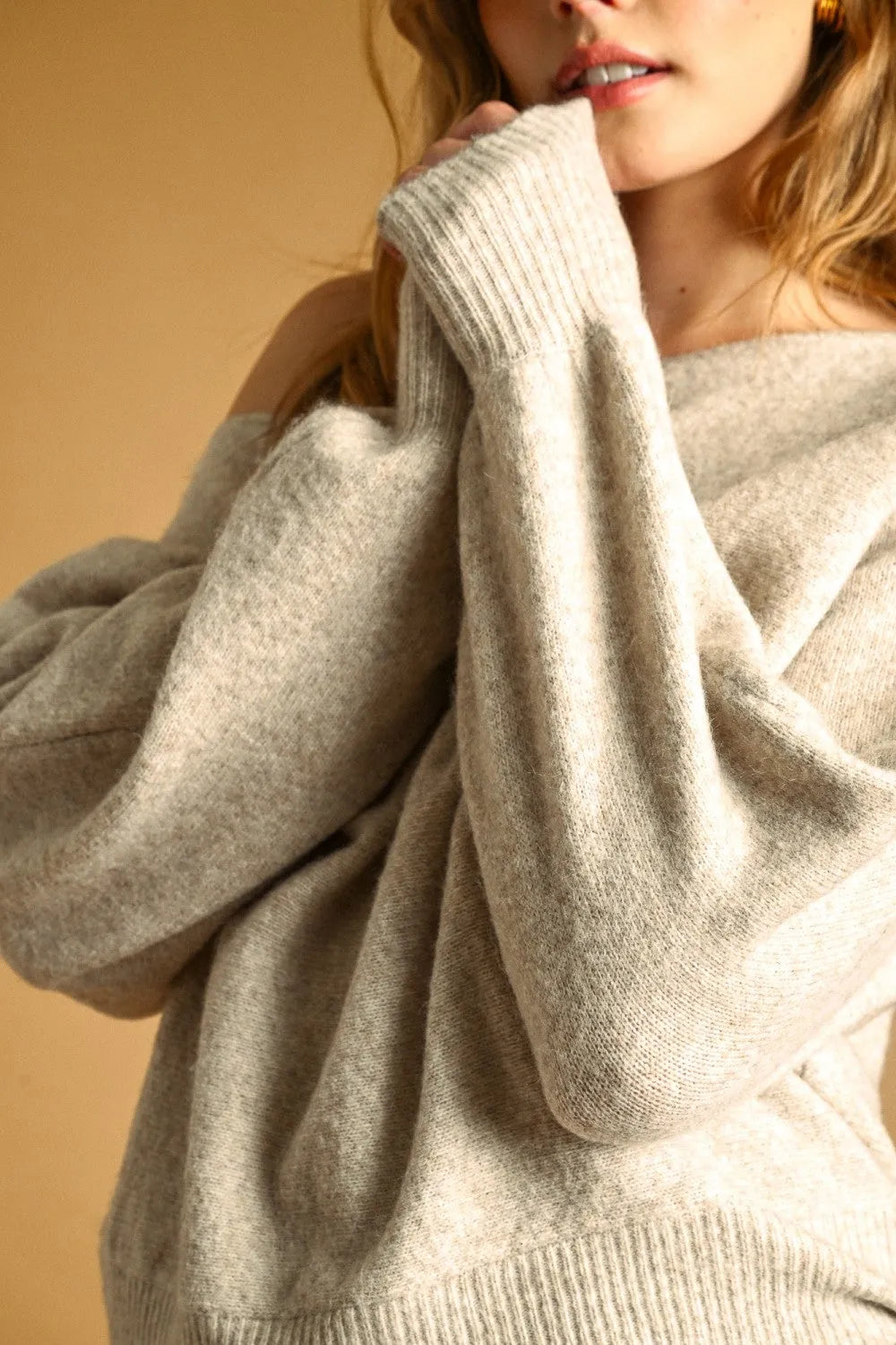 A cozy beige long sleeve boat neck top sweater in knit fabric with ribbed cuffs and hem for casual wear