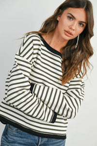 Striped loose fit long sleeve top with bold black and white vertical stripes