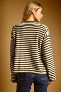 A cozy oversized sweater with striped pattern rolled neck detail in olive green and cream for casual wear