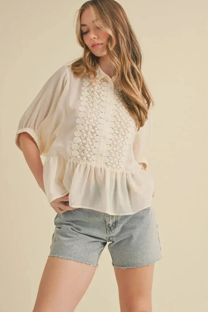 Lace trimmed button blouse in cream with lace details and peplum hem