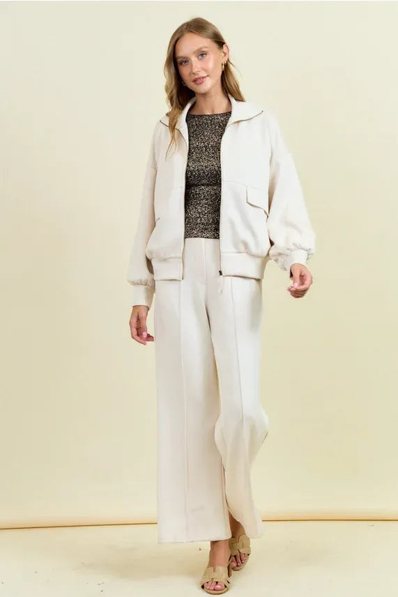 Cream-colored buttery soft flap pocket jacket with relaxed fit bomber style and ribbed cuffs for casual wear
