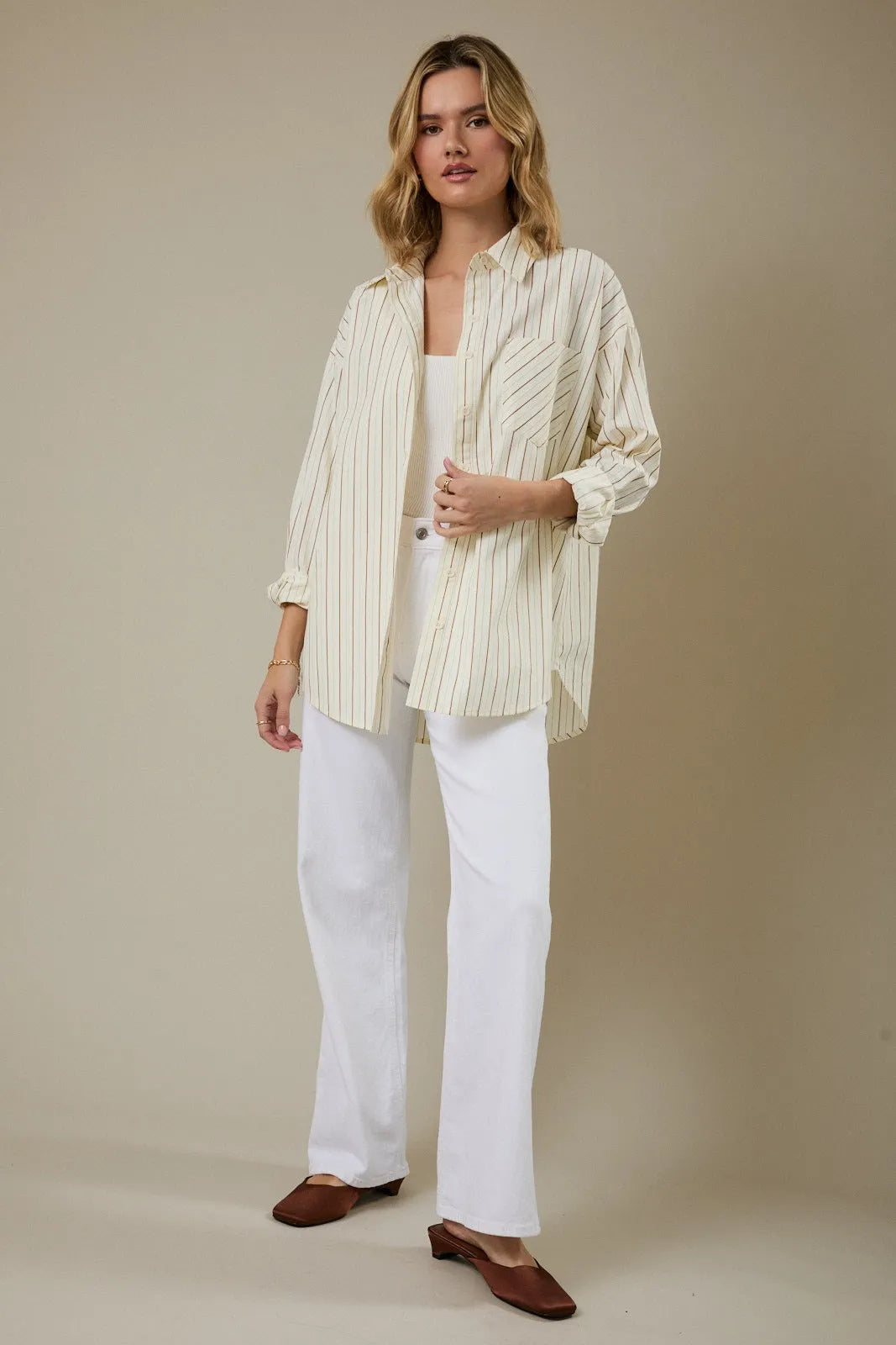 Cream-colored stripe classic button shirt with thin vertical stripes made from lightweight fabric for all-day comfort