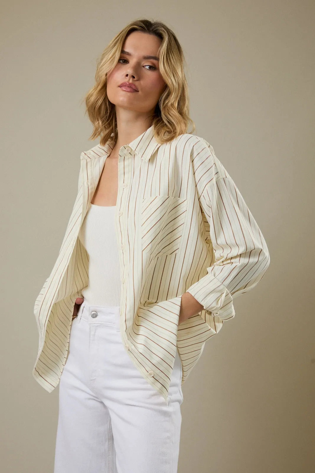 Cream-colored stripe classic button shirt with thin black pinstripes and relaxed fit for versatile wear