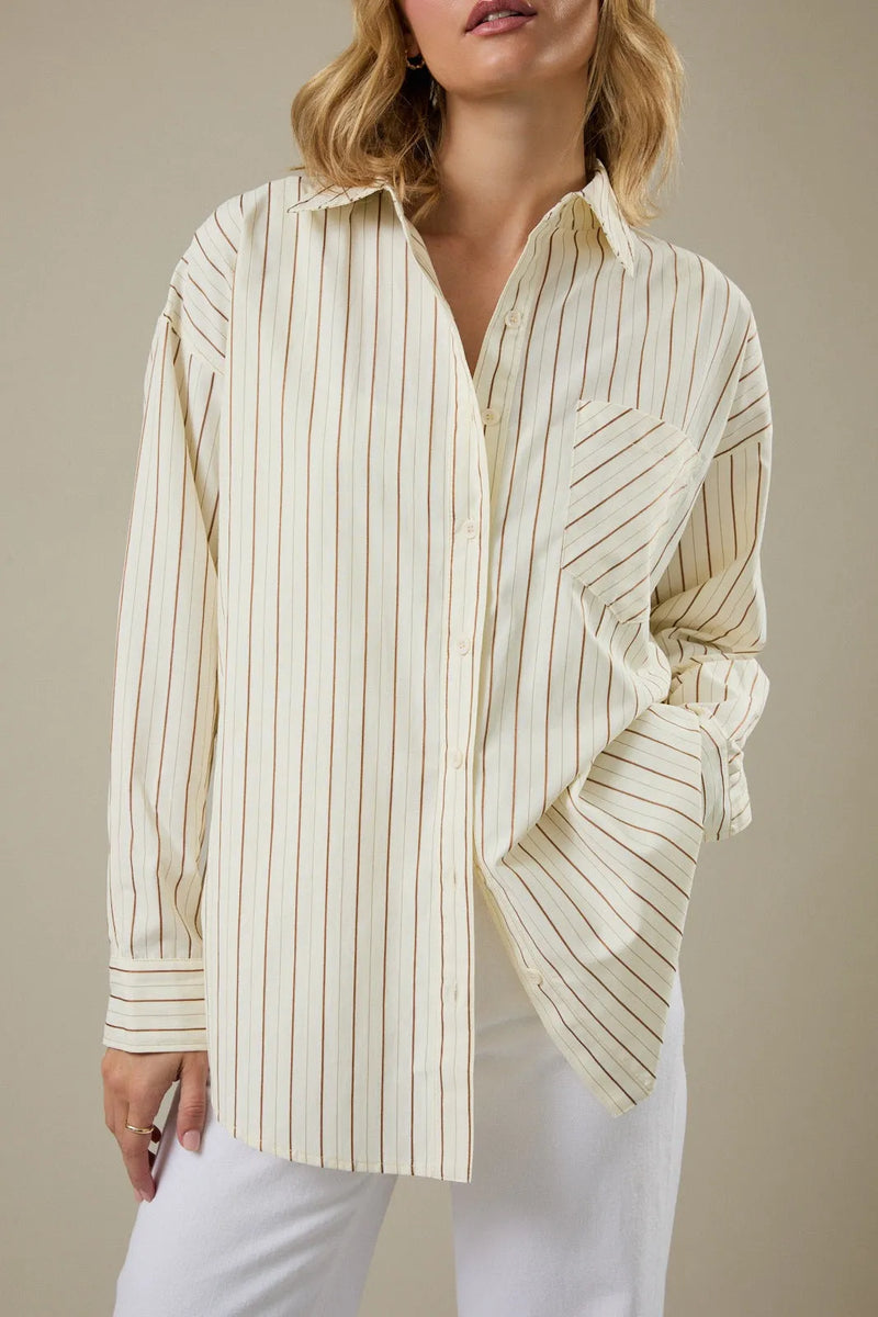 Cream-colored stripe classic button down shirt with thin vertical brown stripes and a relaxed fit