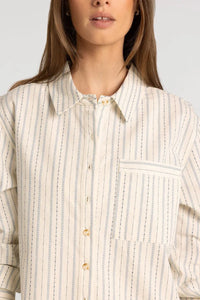 A cream-colored thread and supply lexington shirt with soft blue vertical stripes and chain-like seam detailing