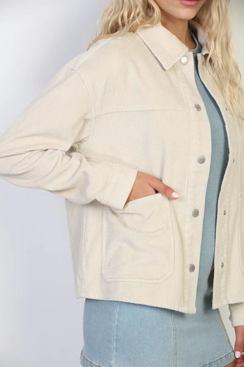 Cream-colored garment washed corduroy chore jacket with button-up front and two patch pockets in washed corduroy fabric