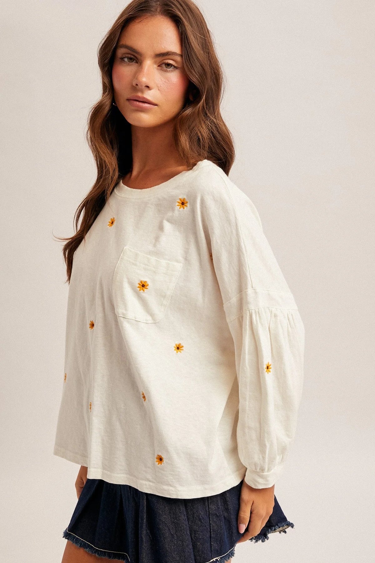 Daisy embroidered long sleeve top in cream cotton with yellow floral embroidery