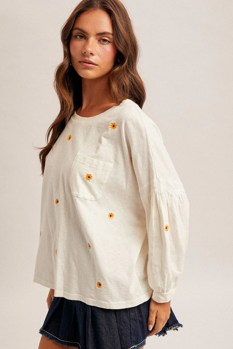 Daisy embroidered long sleeve top in cream cotton with yellow floral embroidery